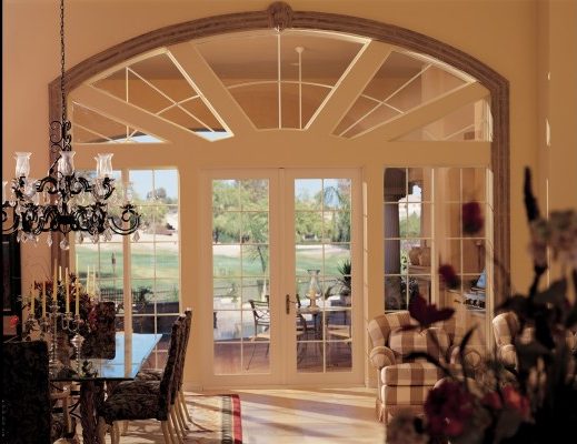 Large dining area in a home; focus on large, custom French doors with custom side lights.