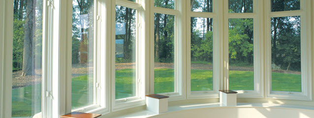 Weather Shield casement windows in a curved row, with view of grass and trees.