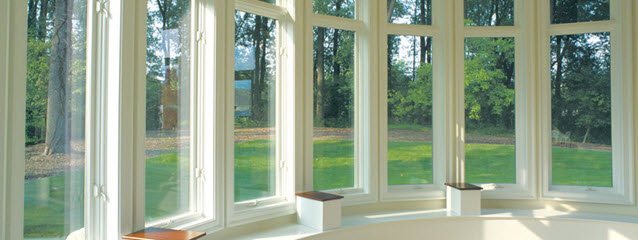 Weather Shield casement windows in a curved row. View of grass and trees outside.