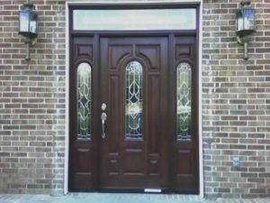 Dark wood entry door on a brick home in Maryland installed by Quality Window & Door