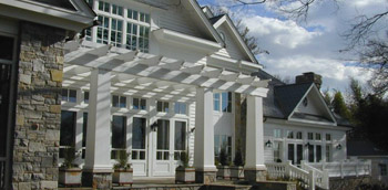 new construction windows installed in a new home with white siding and a large stone column to the left.