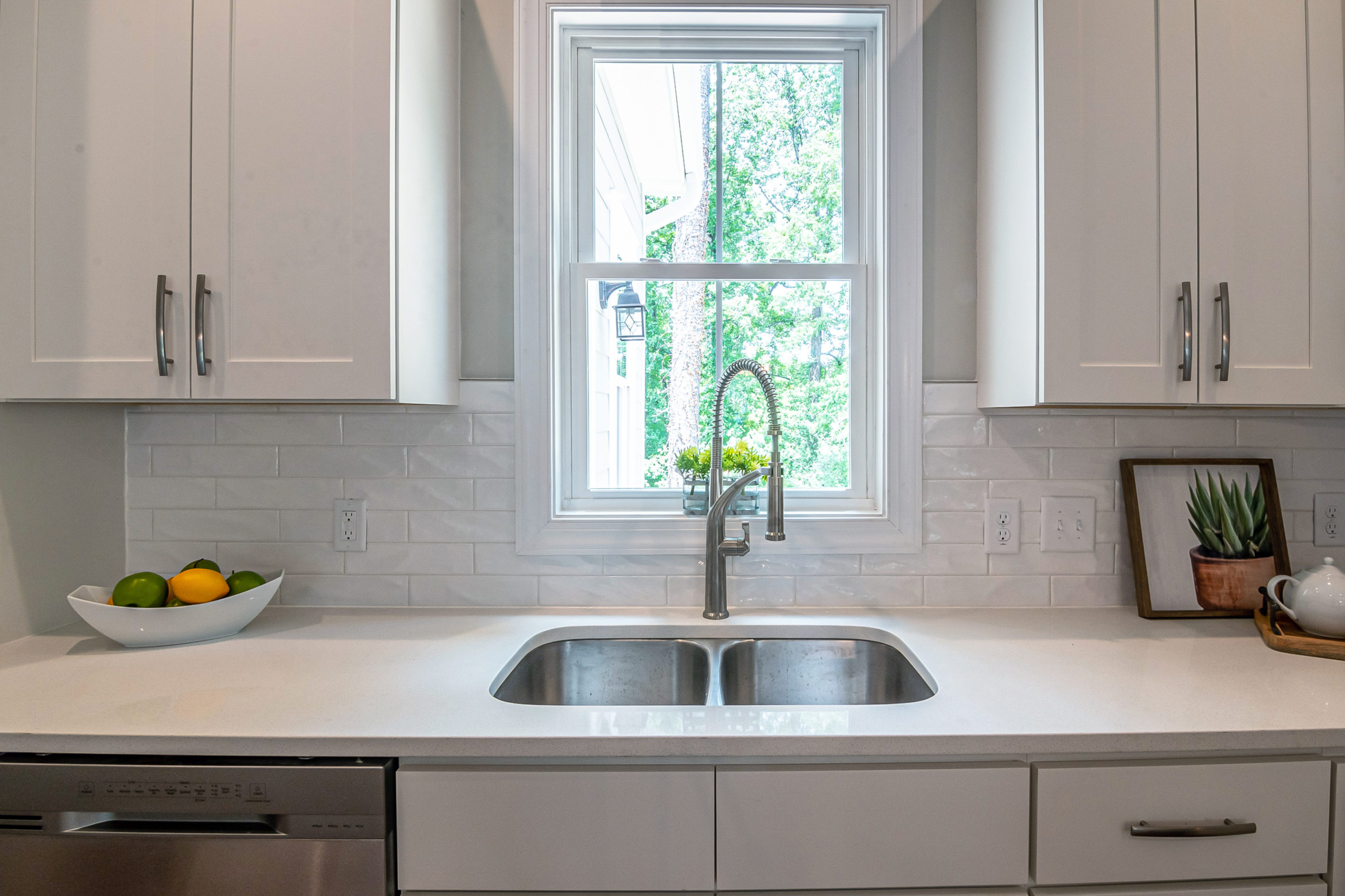 Bright, clean kitchen with a new window behind kitchen sink.