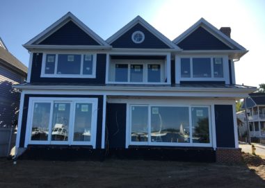 Exterior of home with new vinyl sliding glass and picture windows installed