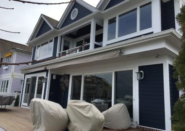 Back view of home with new sliding glass doors and windows