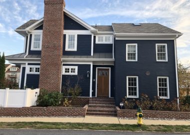 Exterior of new construction home with new double hung windows and entry door