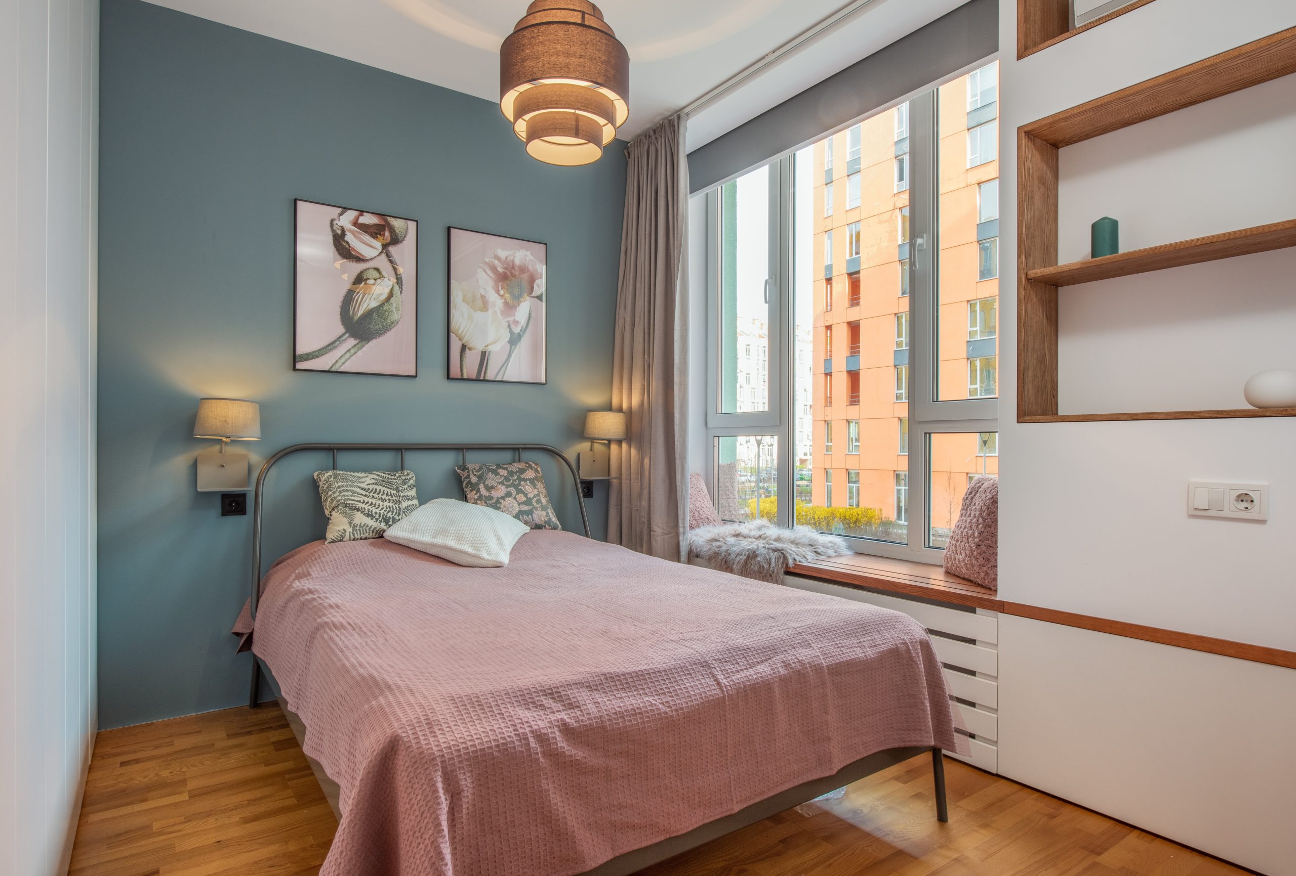 Large picture window with casement windows on either side in a small bedroom.