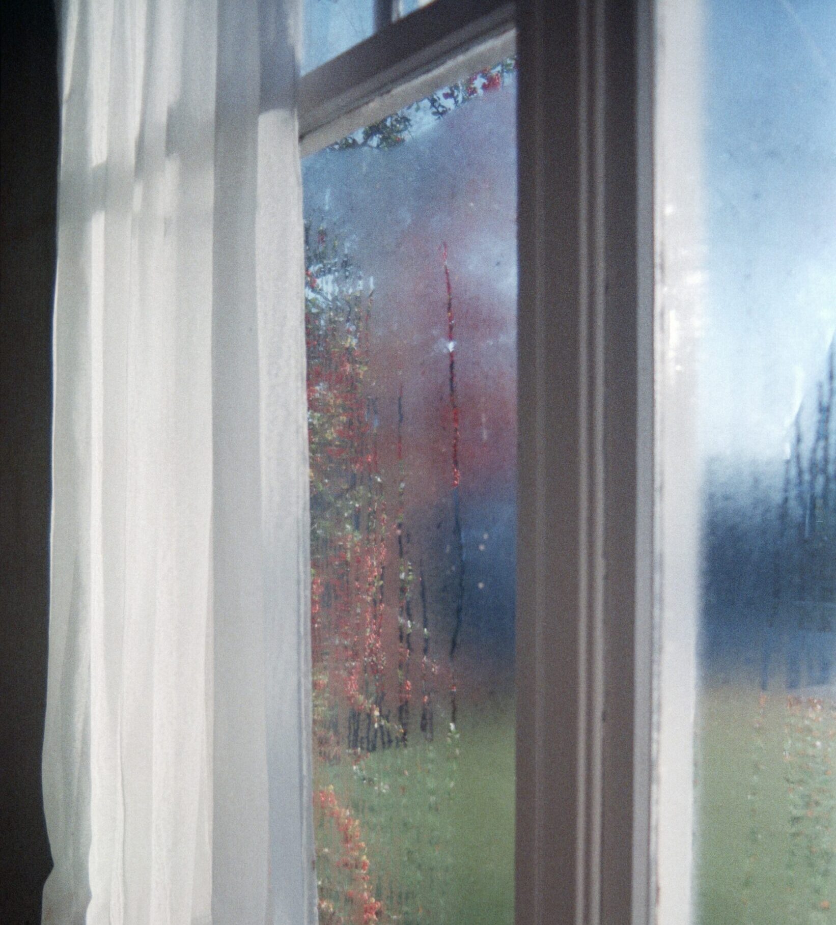 Close view on window with condensation and fog between the glass panes.
