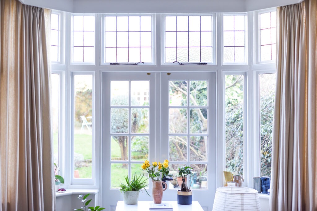 Stylish room interior with french doors and light neutral colours in a modern home.